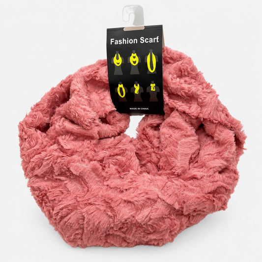 Pink plush infinity scarf arranged in a loop with a product tag