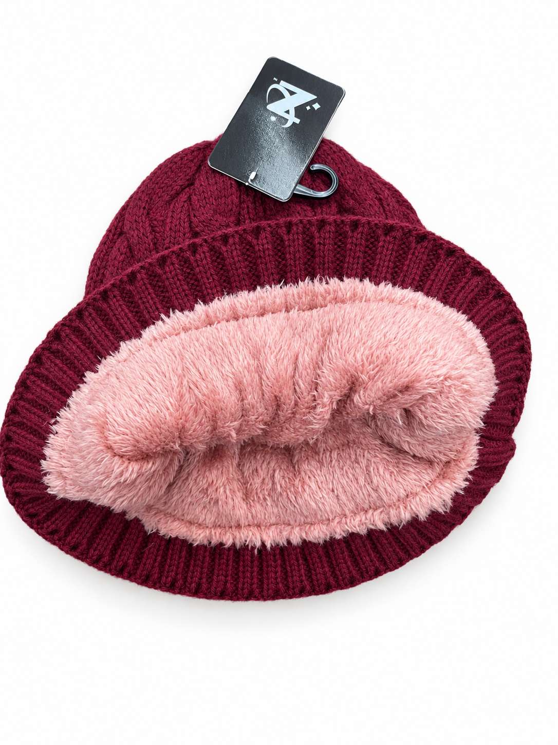Burgundy cable-knit beanie turned outward to show pink plush lining