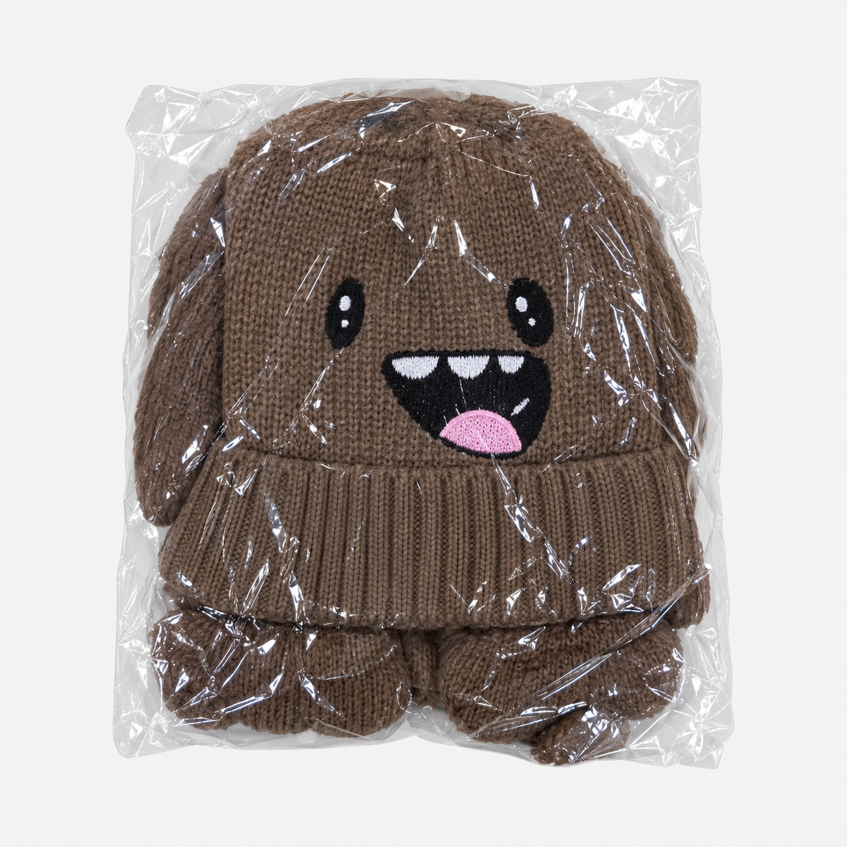 Brown monster-face knit hat in individual packaging