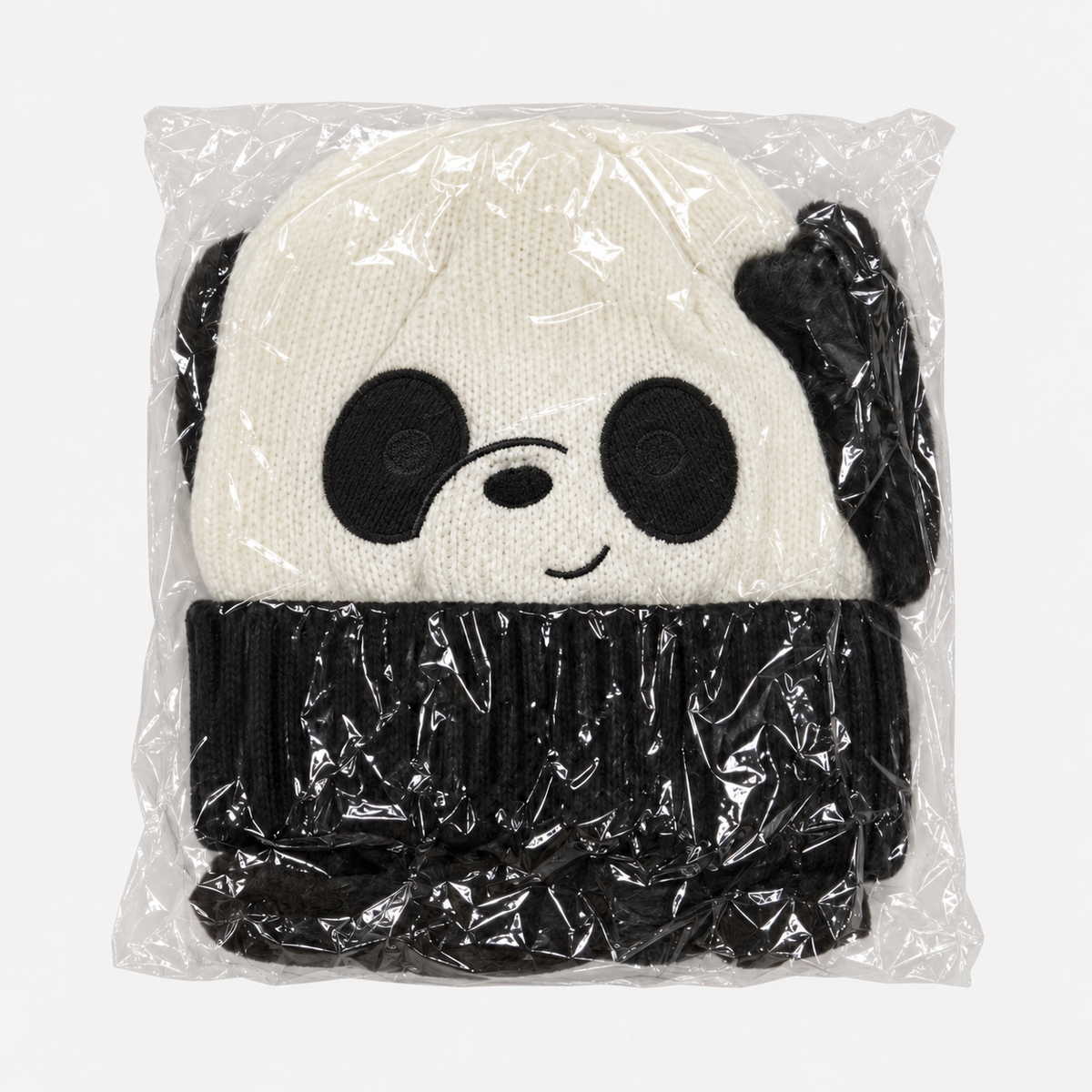 Cream and black panda knit hat in individual packaging