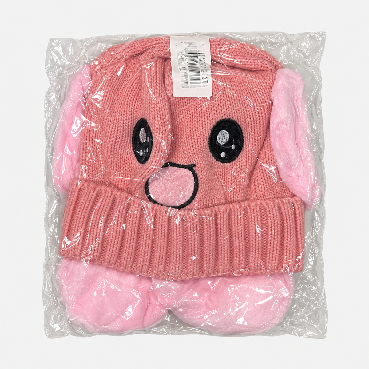 Pink happy-face knit hat in individual packaging