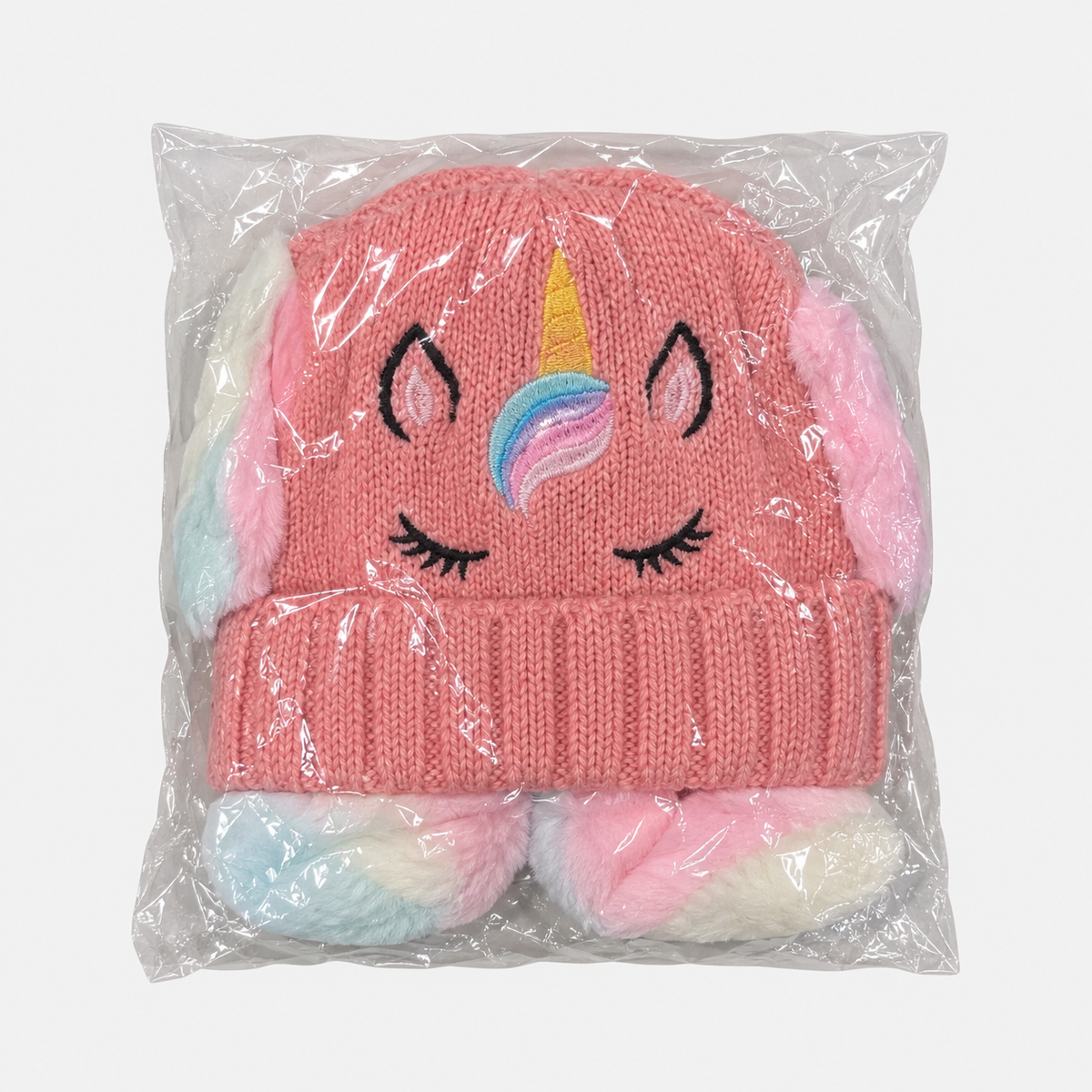 Pink unicorn knit hat in individual packaging