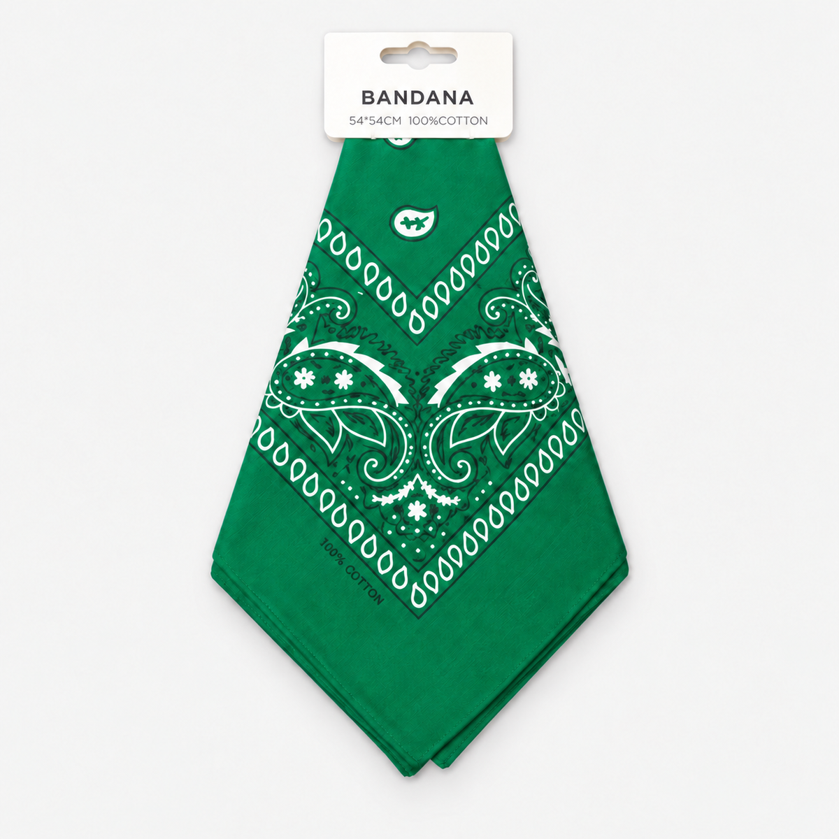 One green cotton paisley bandana with retail hang tag on a light gray background.