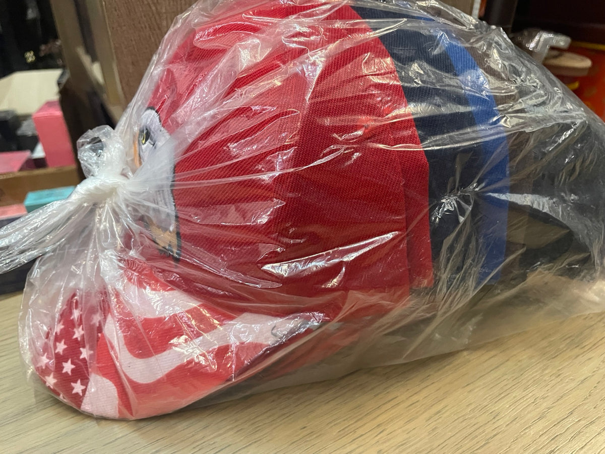 Original side view of eagle caps packed in a clear bag on a light gray background