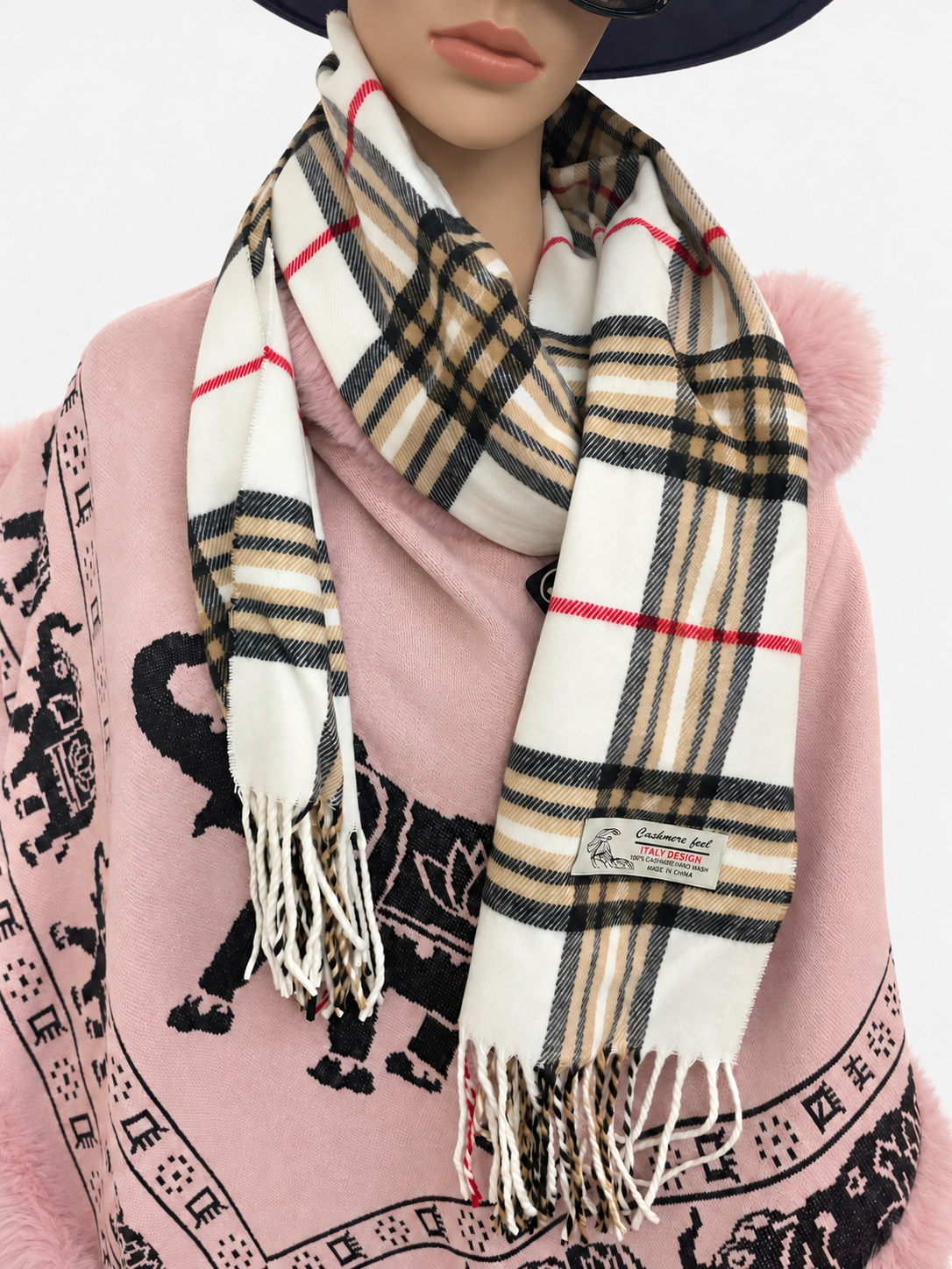 Cream plaid fringe scarf worn on a mannequin, showing its drape and fringed ends
