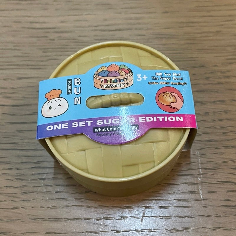 Individually packaged small dumpling squishy toy in a round container