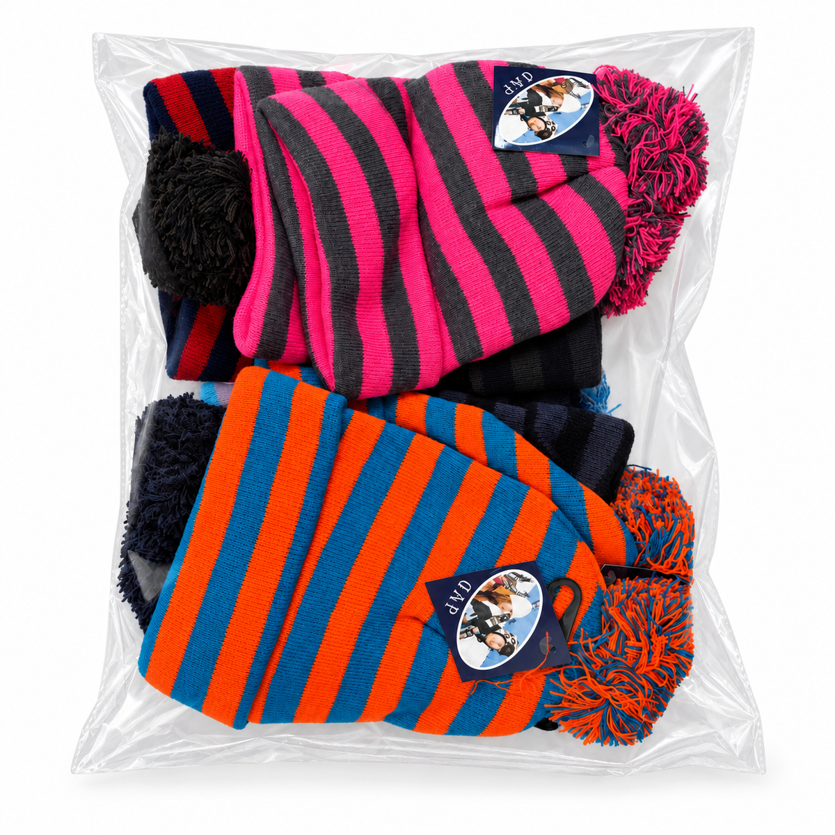 Pink-and-black and orange-and-blue striped pom-pom beanies in clear packaging