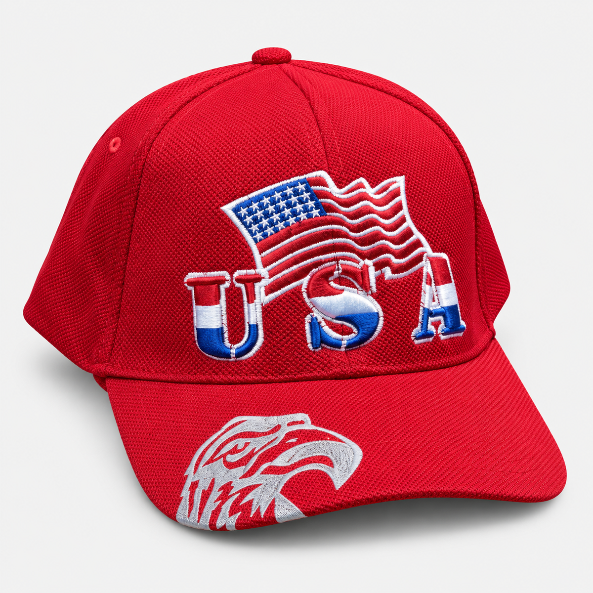 Red baseball cap with embroidered USA lettering, an American flag and an eagle graphic on the brim