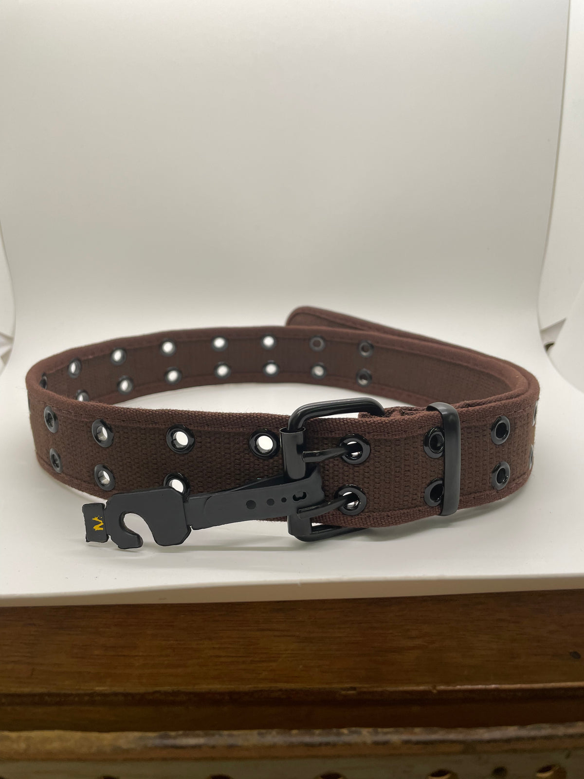 Brown belt with double rows of eyelets and buckle