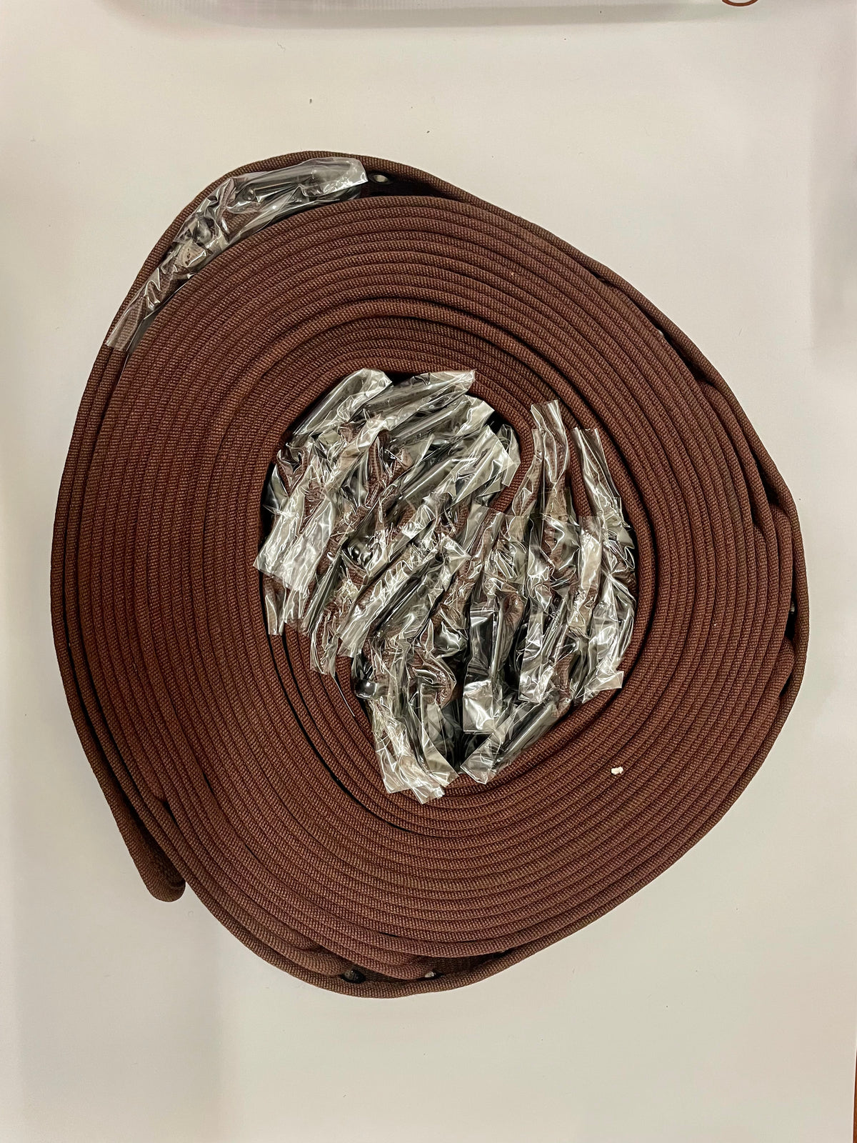 Coiled brown belts with packaged buckles