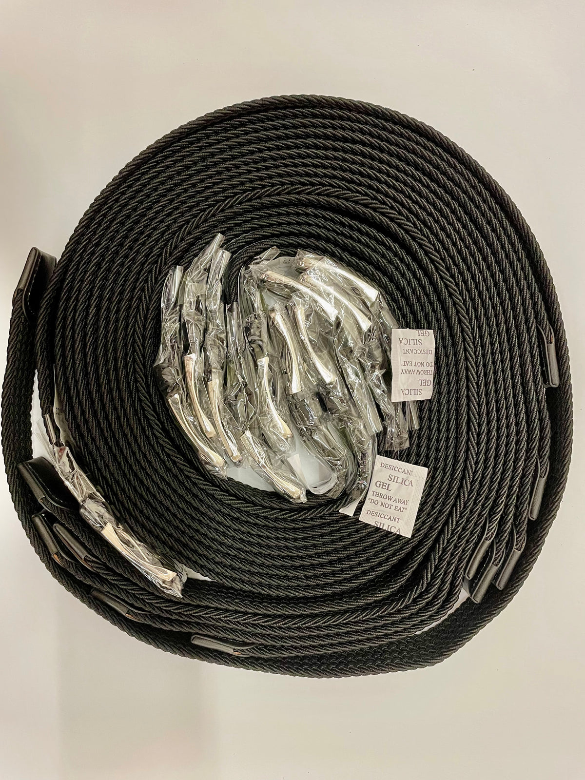 Coiled black woven stretch belts