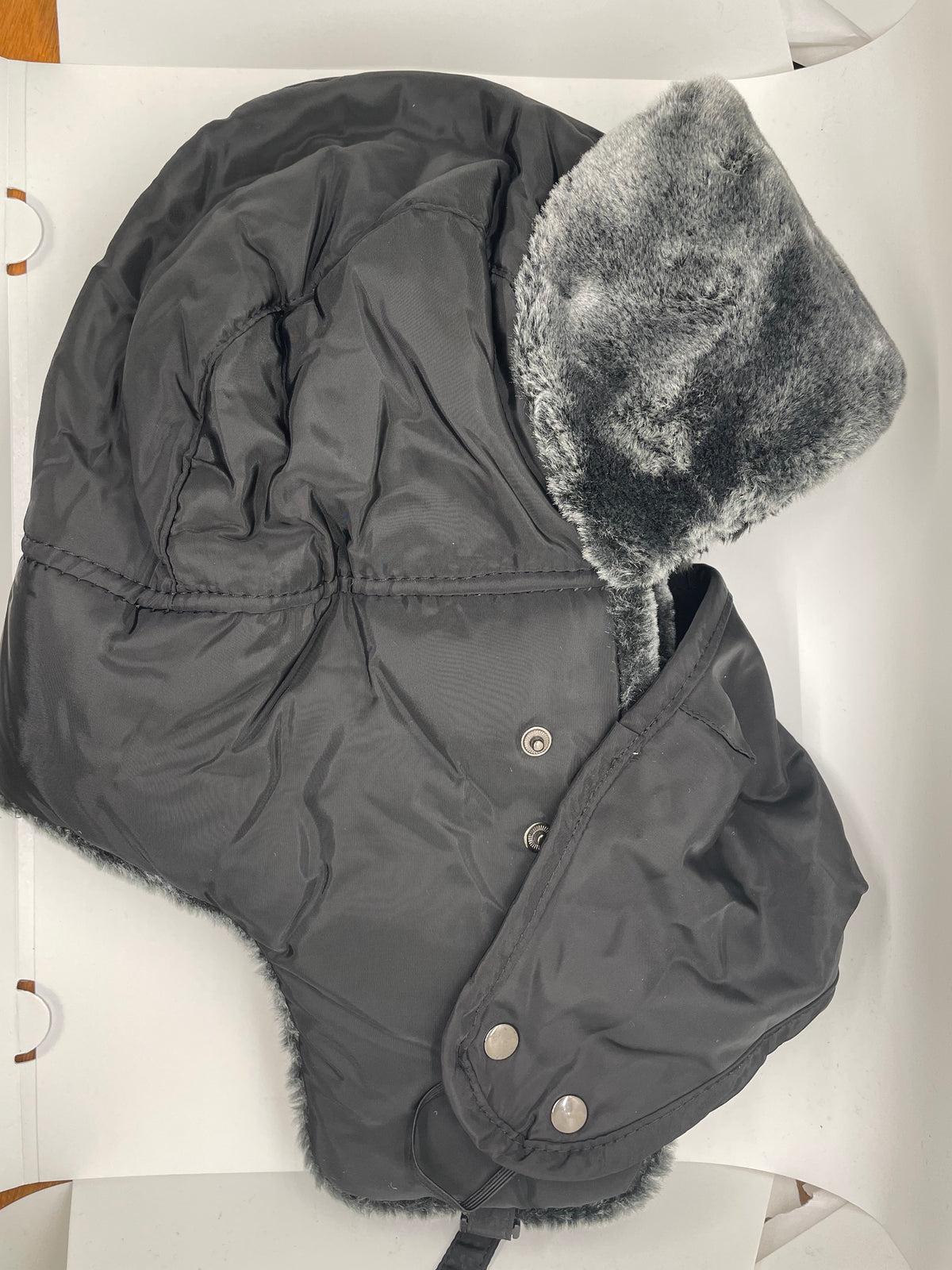 Black ushanka hat with ear flaps and furry trim