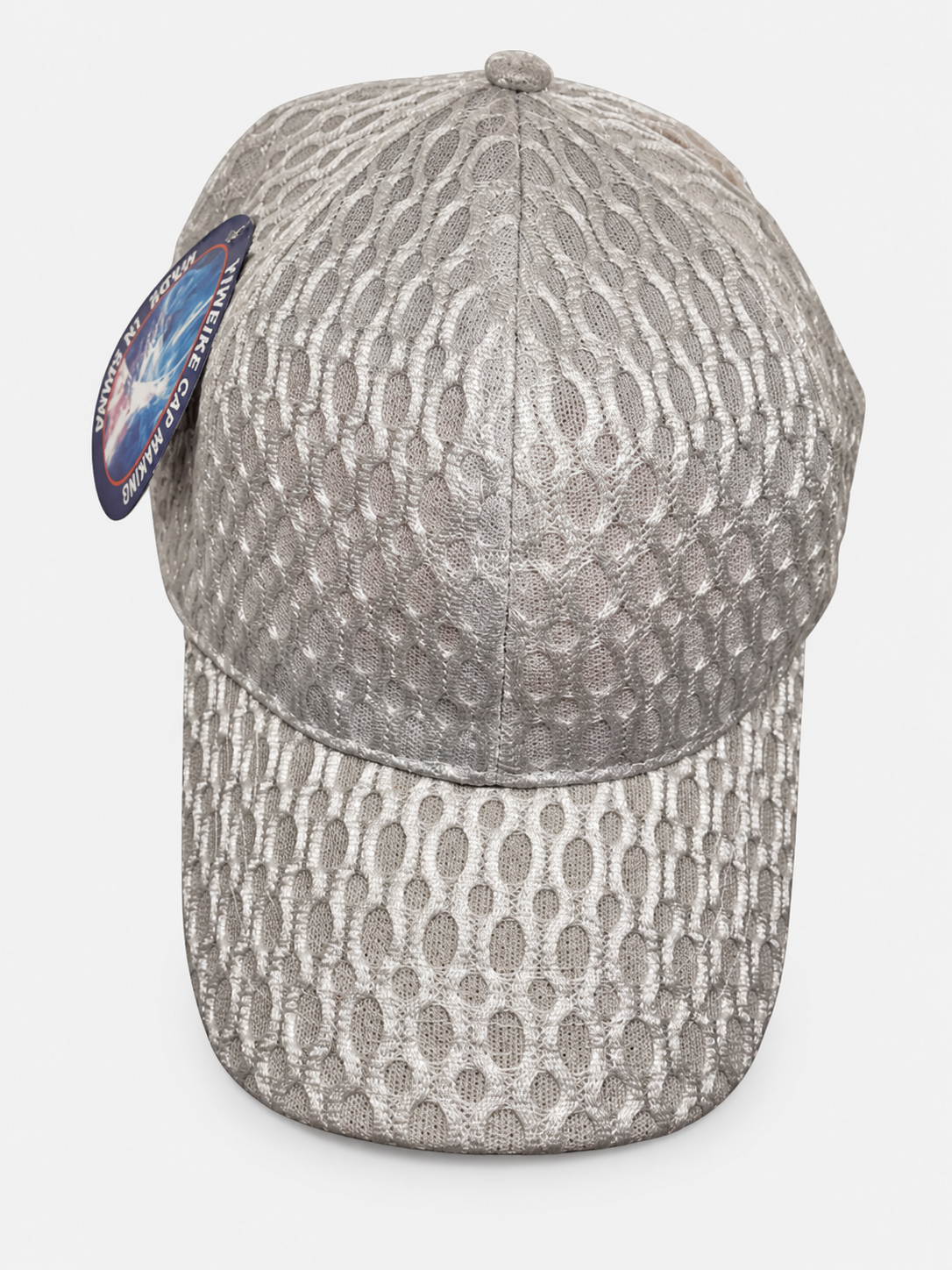 Light gray netted baseball cap with oval pattern on a light gray background