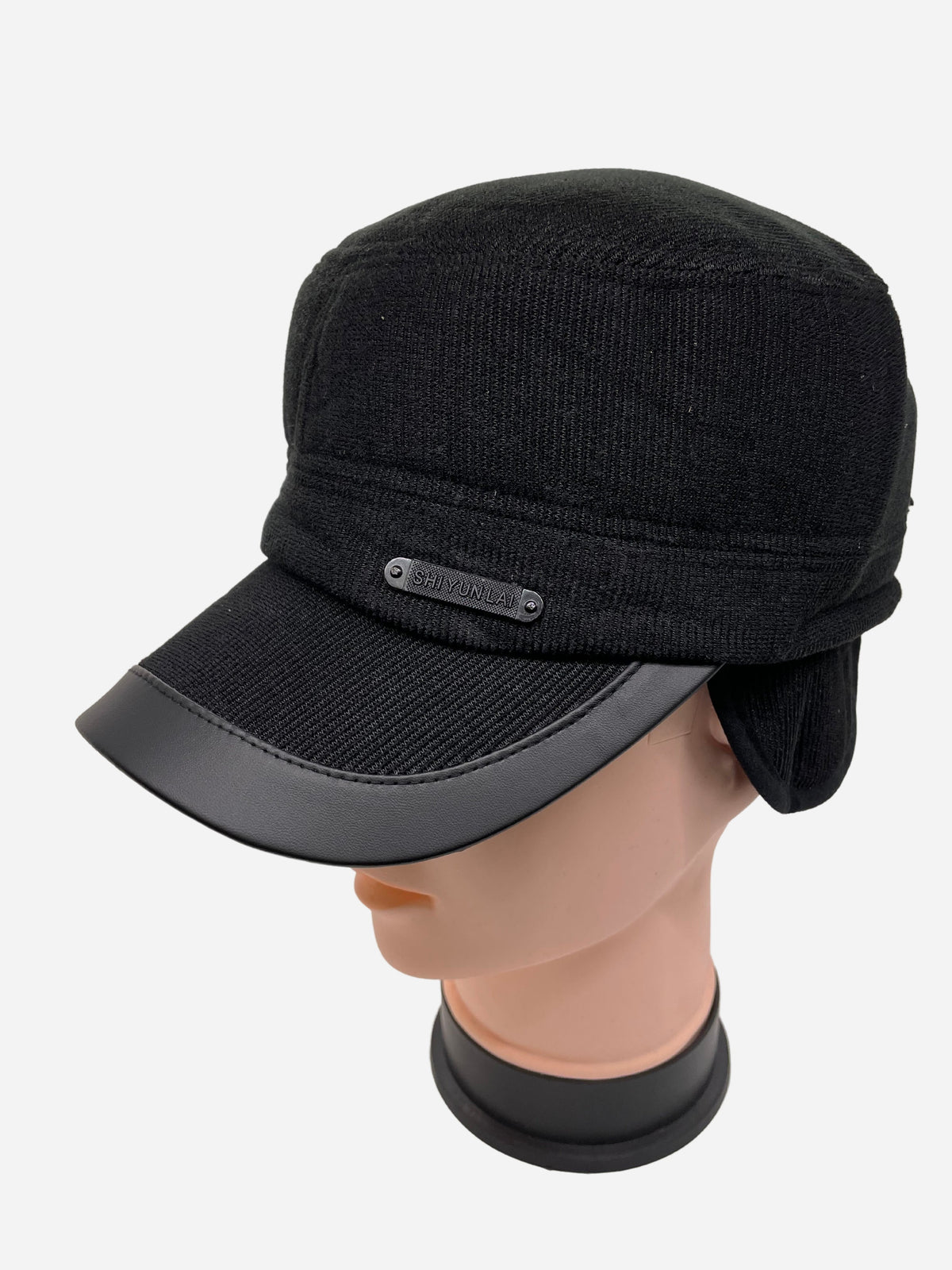 Black winter cap with a short curved brim and ear flaps